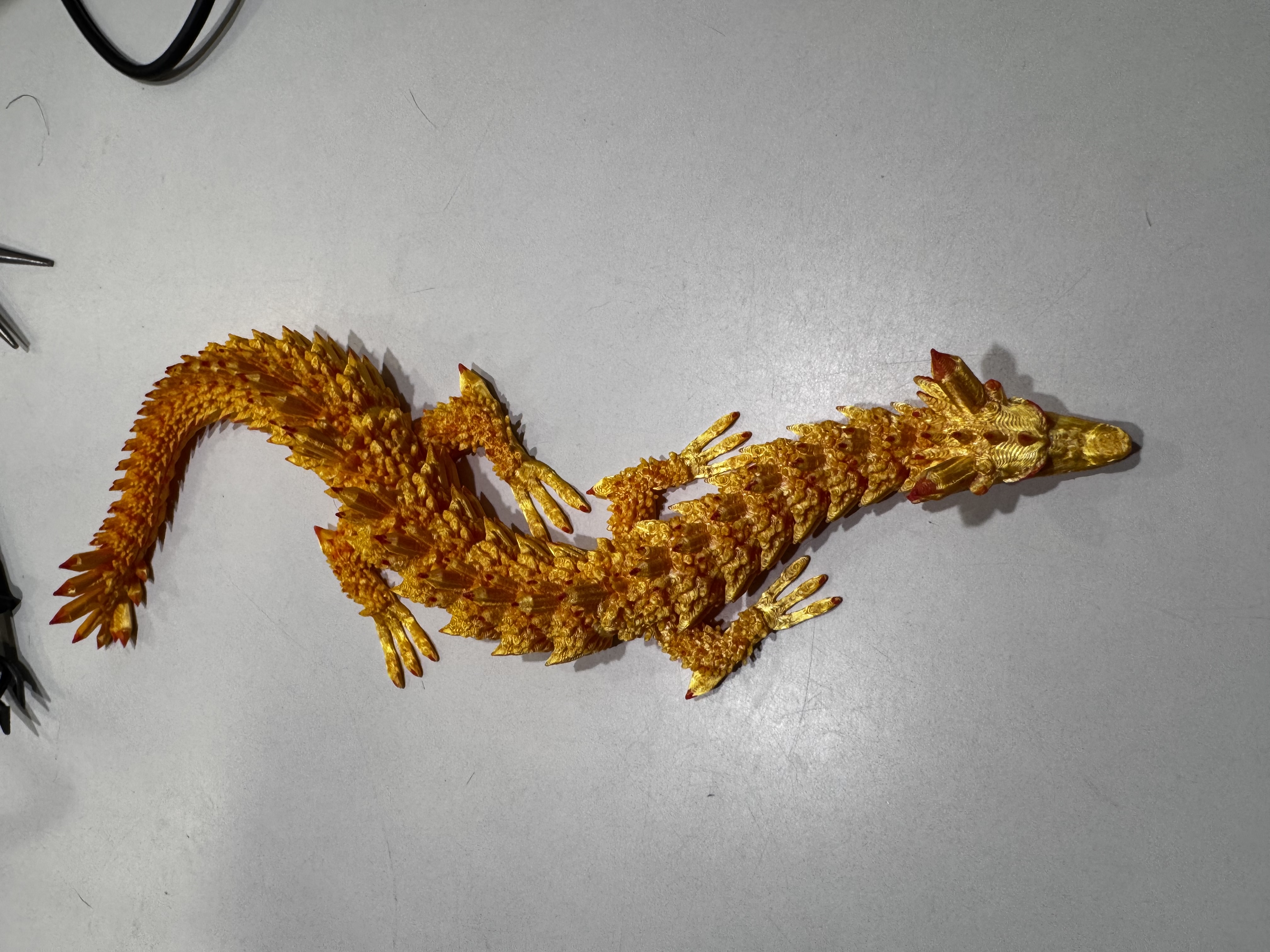Gold articulated dragon hand-painted with red claws